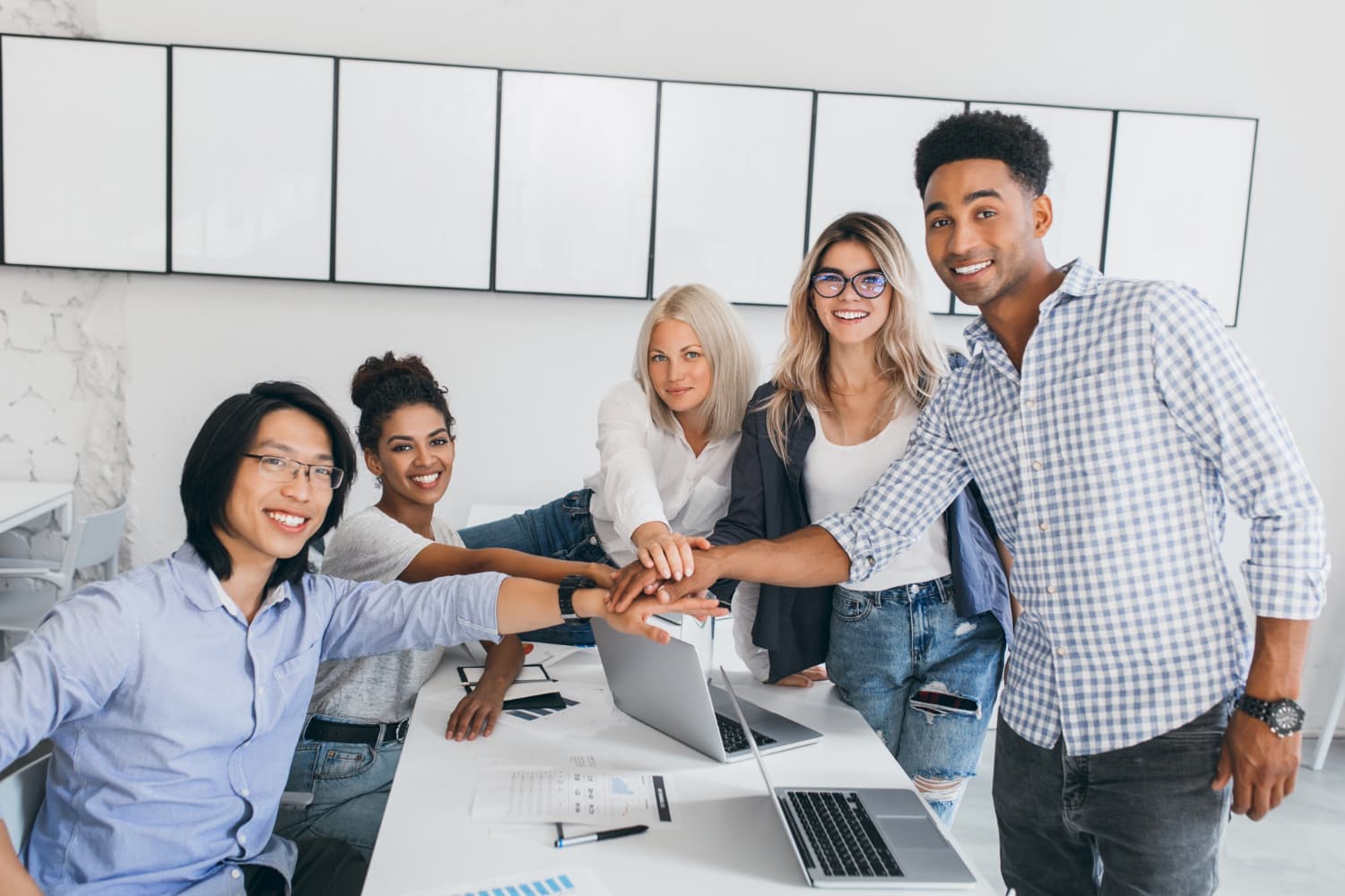 Image depicting multiple people working together in our team